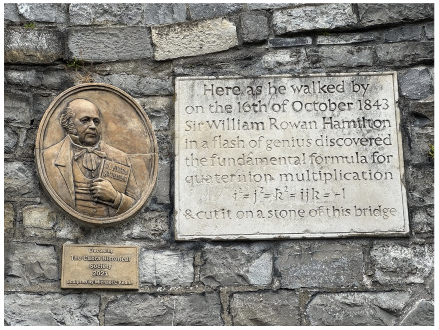 The famous inscription on the side of Boom Bridge in Galway, Ireland, about Hamilton discovering the Quaternions is shown, as well as a bust of Hamilton.
